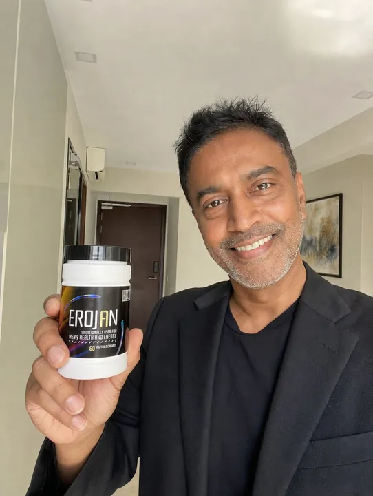 An EROJAN customer in Singapore holding their bottle