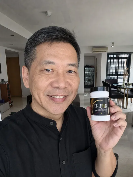 An EROJAN customer in Singapore holding their bottle