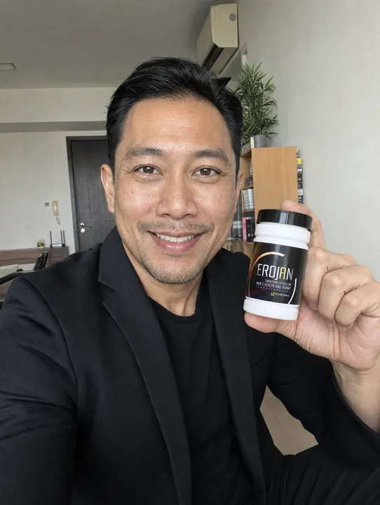 An EROJAN customer in Singapore holding their bottle